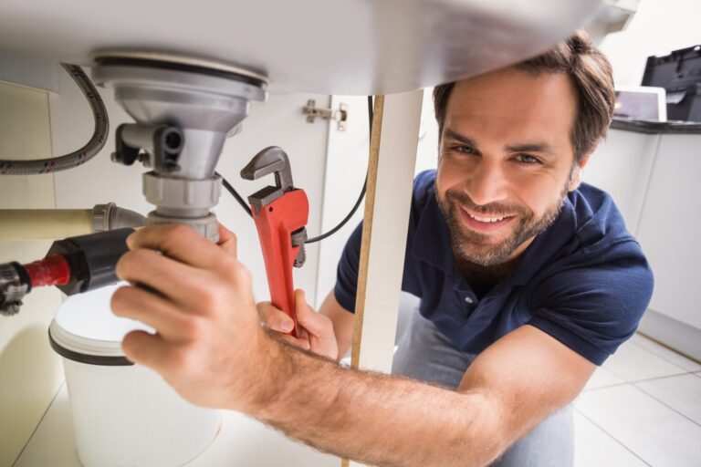 Plumber-fixing-under-the-sink