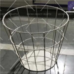 Industrial-grade white powder-coated wire basket manufacturers with a solid base for retail and warehouse storage.
