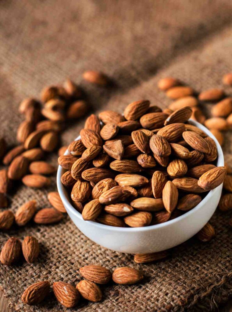 Best flavoured almonds brands in India displayed in bowls with different roasted and seasoned almond varieties.