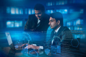 two young Indians working at office on laptop