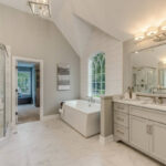 Soaking tub near a decorative window