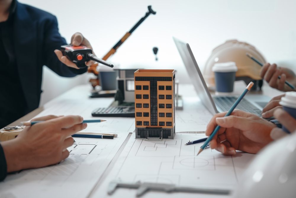 Architectural Design Services Team Reviewing Building Model