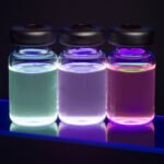 Three glass vials containing fluorescent cadmium sulfide (CdS) quantum dots for nanotechnology, imaging, and scientific research