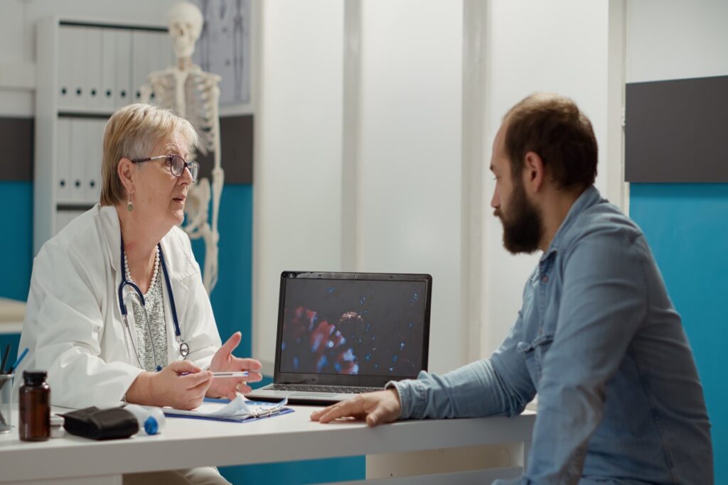 female-medic-looking-coronavirus-illustration-laptop-with-sick-patient-talking-about-medication-prevention-virus-animation-display-cure-disease-medical-cabinet (1)