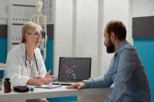 female-medic-looking-coronavirus-illustration-laptop-with-sick-patient-talking-about-medication-prevention-virus-animation-display-cure-disease-medical-cabinet (1)