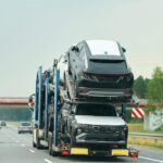 new-suvs-being-loaded-transport-truck_782515-18351 (1)