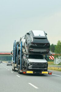 new-suvs-being-loaded-transport-truck_782515-18351 (1)