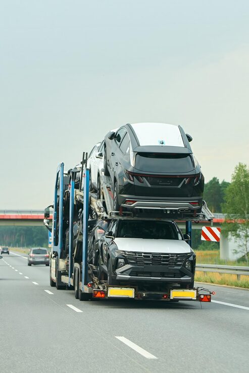 new-suvs-being-loaded-transport-truck_782515-18351 (1)