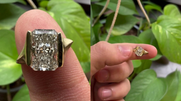 Close-up of a radiant cut diamond statement ring in yellow gold with bold geometric side accents displayed on a fingertip.
