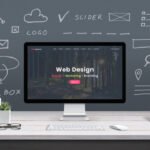 A computer screen displaying a website layout surrounded by wireframe sketches representing comprehensive web design and development services.