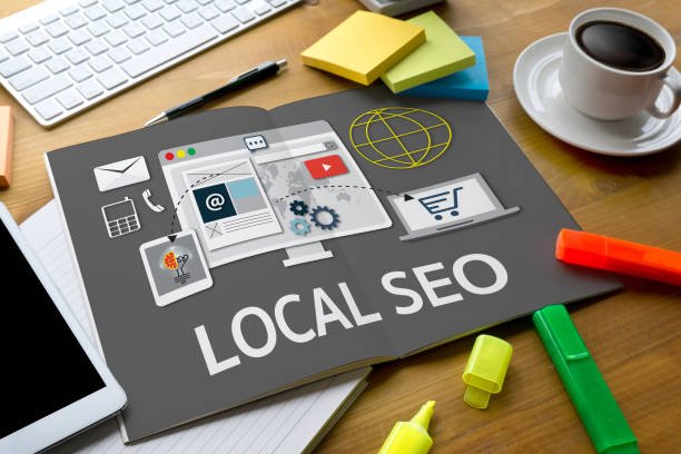A desk workspace displaying a booklet with LOCAL SEO diagrams, illustrating services provided by a top local SEO agency London.