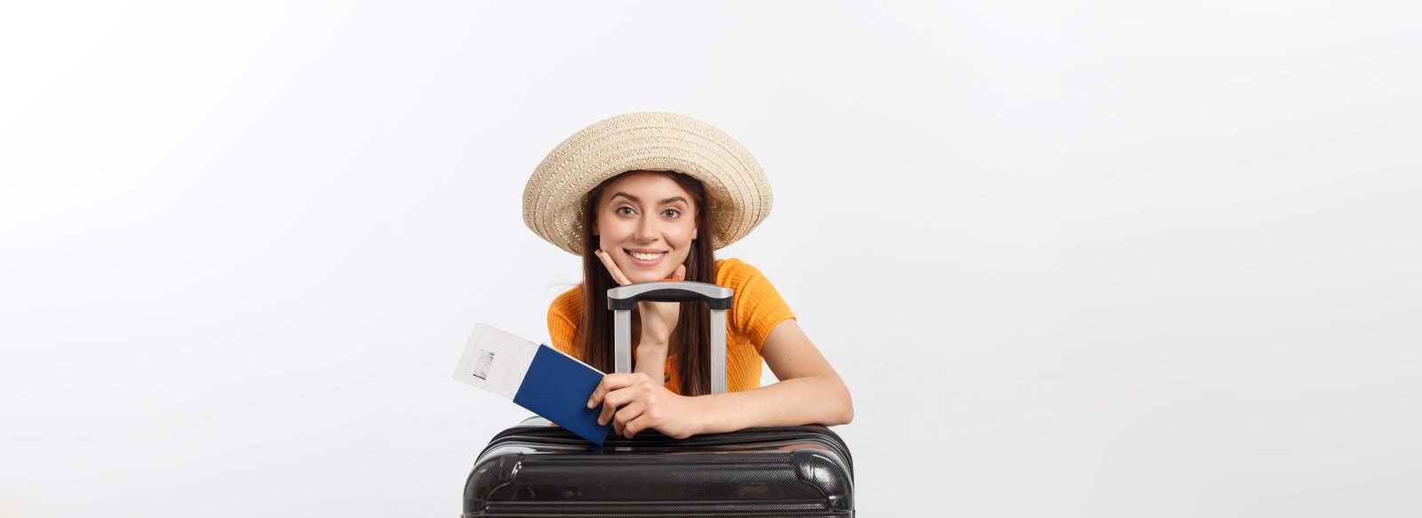 Travel concept. Studio portrait of pretty young woman holding passport and luggage. Isolated on white