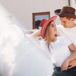 Beautiful couple spend time with a horses