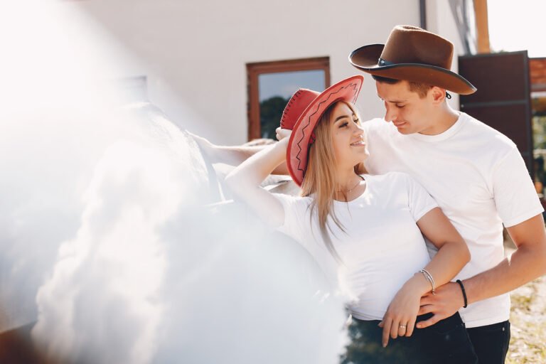 Beautiful couple spend time with a horses