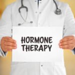 Doctor holding a white paper, Hormone Theraphy written on paper.