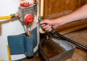 plumbers-hand-connecting-drain-hose-to-water-heater