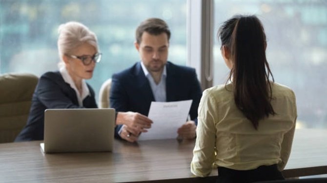 Interviewer checking the resume of a candidate